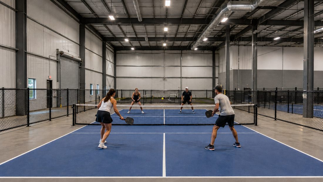 Indoor pickleball courts inside a warehouse facility